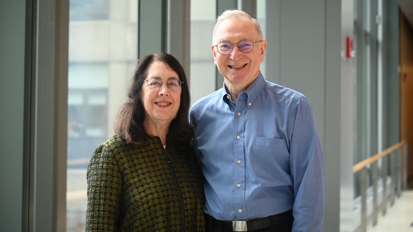 Drs. Arlene Sharpe and Gordon Freeman stand together for a portrait.