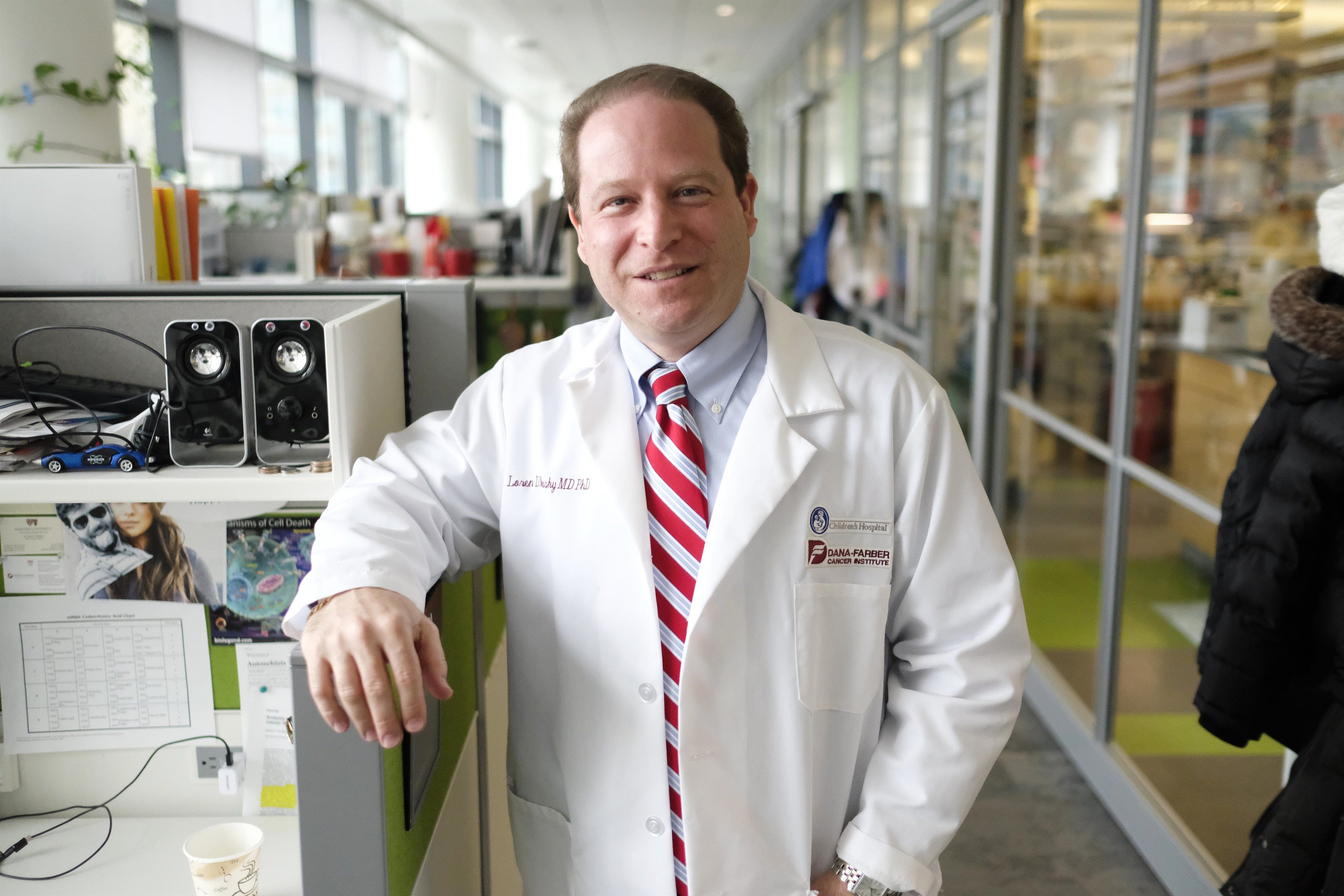 A photo of Loren Walensky in a white coat