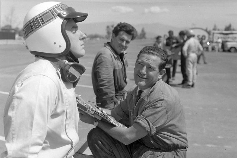 Jackie Stewart on the pit wall with a BRM mechanic.