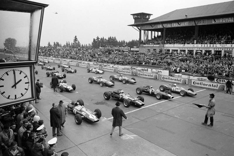 Pole sitter Jim Clark, Lotus 33 Climax waits alongside John Surtees, Cooper T81 Maserati, Jackie Stewart, BRM P261 and Ludovico Scarfiotti, Ferrari 246 on the front row of the grid.