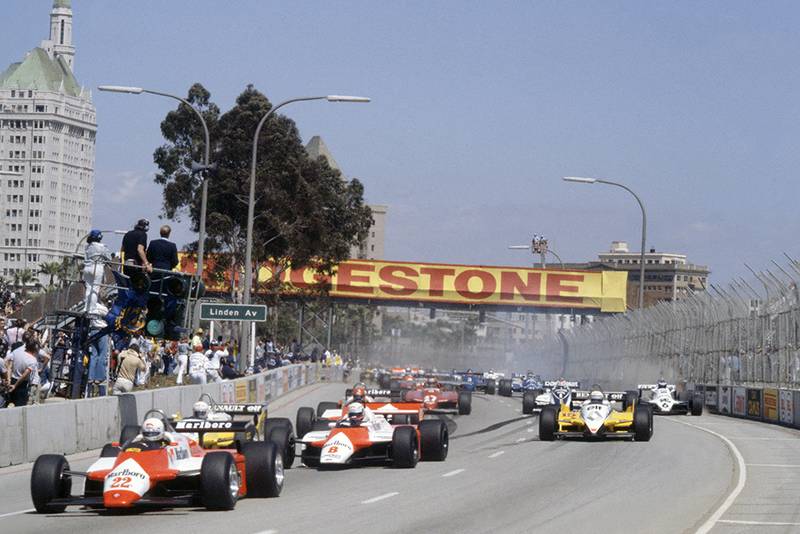 Andrea de Cesaris (Alfa Romeo 182) leads Niki Lauda (McLaren MP4/1B-Ford Cosworth), Rene Arnoux, Alain Prost (both Renault RE30B), Bruno Giacomelli (Alfa Romeo 182), Gilles Villeneuve (Ferrari 126C2), Nelson Piquet (Brabham BT49D-Ford Cosworth) and Keke Rosberg (Williams FW07C-Ford Cosworth) at the start.