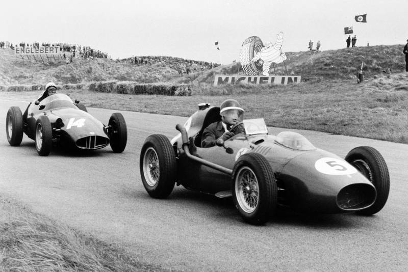 Mike Hawthorn in his Ferrari Dino 246, ahead of Jean Behra in a BRM P25.