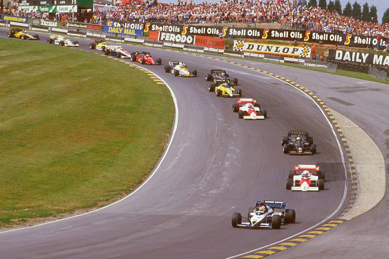 Nelson Piquet (Brabham BT53 BMW) leads Alain Prost (McLaren MP42 TAG Porsche), Elio de Angelis (Lotus 95T Renault), Niki Lauda (McLaren MP42 TAG Porsche), Derek Warwick (Renault RE50) and Nigel Mansell (Lotus 95T Renault) at the start through Paddock Hill Bend.