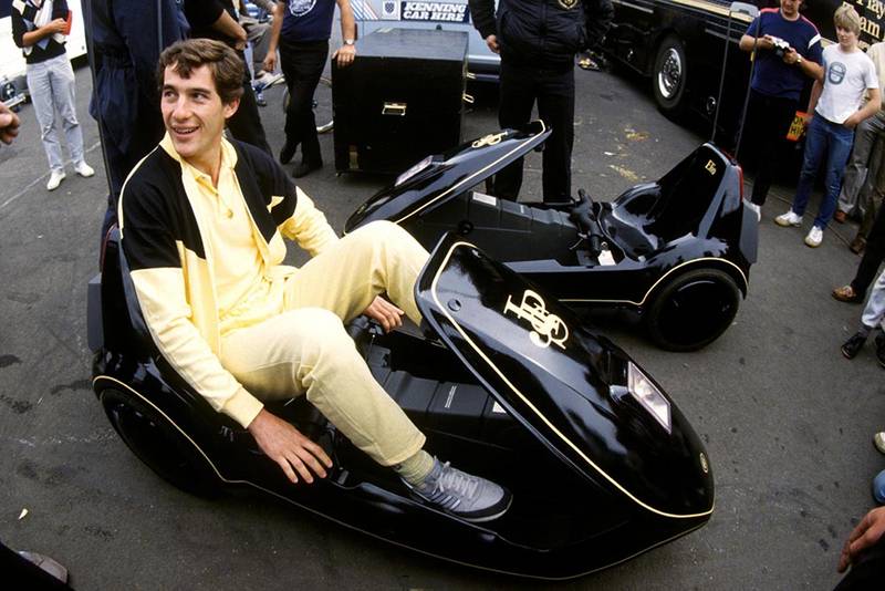 Ayrton Senna Lotus familiarises himself with a JPS liveried Sinclair C5 a revolution in automotive engineering!