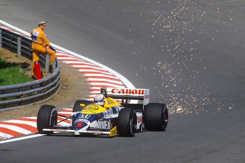 Nigel Mansell showers sparks at Eau Rouge in his Williams FW11 Honda.