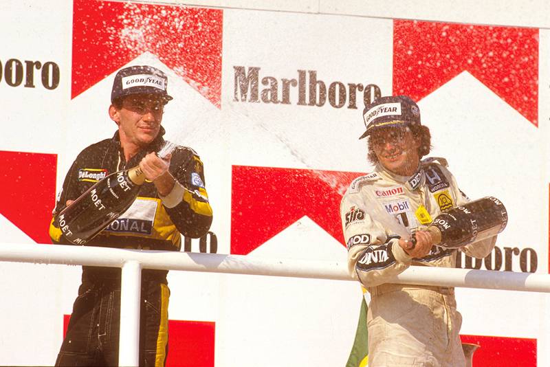 Nelson Piquet, 1st position, with Ayrton Senna, 2nd position on the podium.