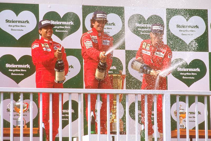 Alain Prost, 1st position, Michele Alboreto, 2nd position and Stefan Johansson, 3rd position on the podium.