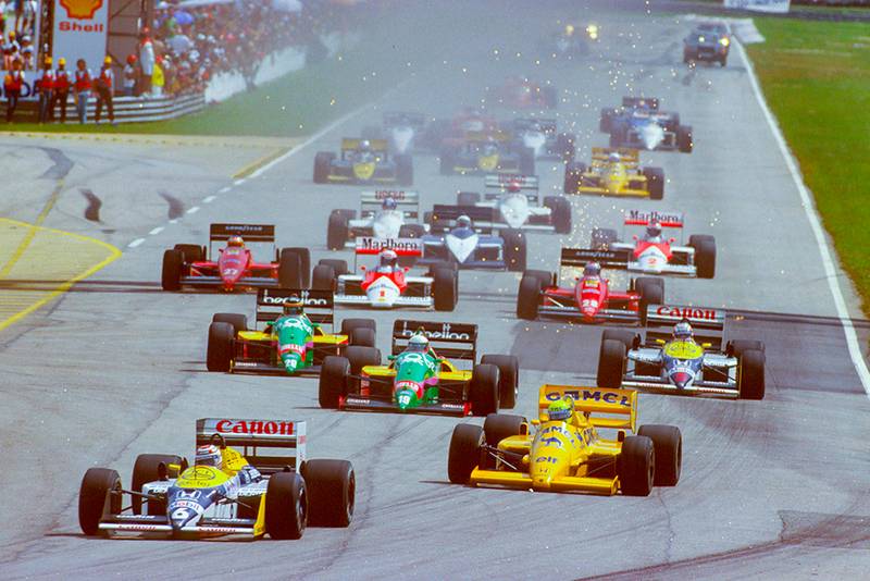Nelson Piquet (Williams FW11B Honda) leads Ayrton Senna (Lotus 99T Honda), Teo Fabi and Thierry Boutsen (both Benetton B187 Ford's) and Nigel Mansell (Williams FW11B Honda) at the start.