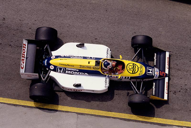 Nigel Mansell driving his Williams FW11B Honda in 1st position.