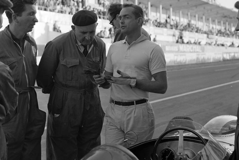 Phil Hill talks to Ferrari mechanics before the race