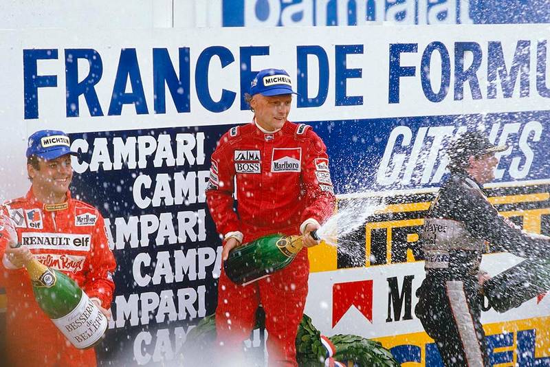 Niki Lauda, 1st position, Patrick Tambay, 2nd position and Nigel Mansell, 3rd position on the podium.