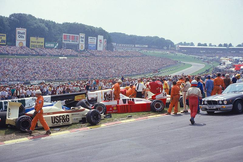 Jacques Laffite is trapped in his Ligier JS27 Renault, after a nine car accident at the start.