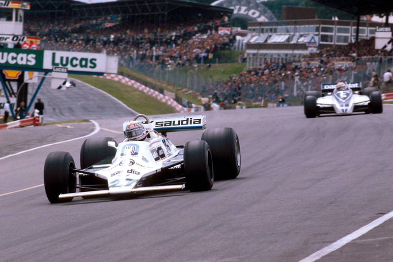 Alan Jones (Williams FW07B Ford) at Paddock Hill Bend, with Nelson Piquet (Brabham BT49 Ford) behind.
