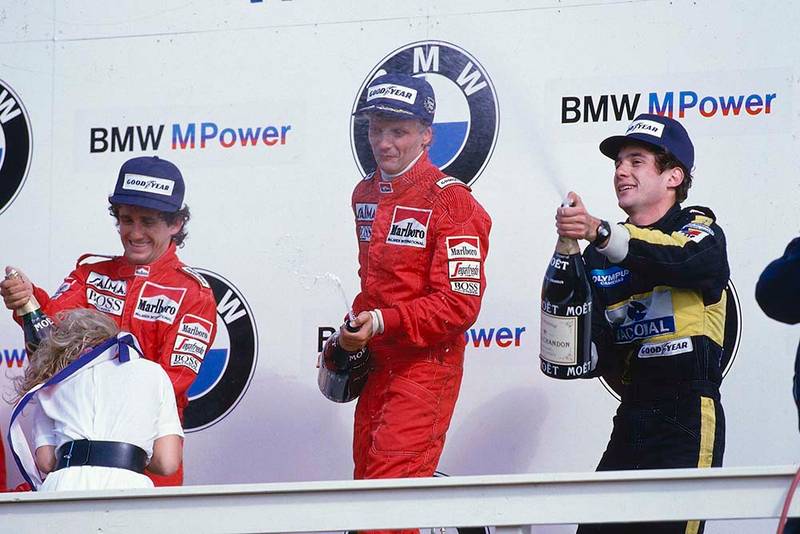 Niki Lauda, 1st position, Alain Prost, 2nd position and Ayrton Senna 3rd position on the podium.