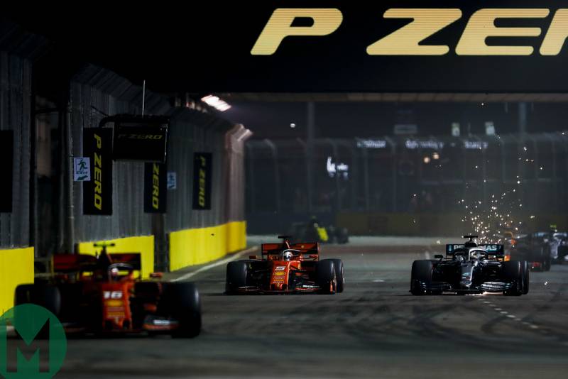Charles Leclerc leads as Sebastian Vettel and Lewis Hamilton go side by side at the Singapore Grand Prix