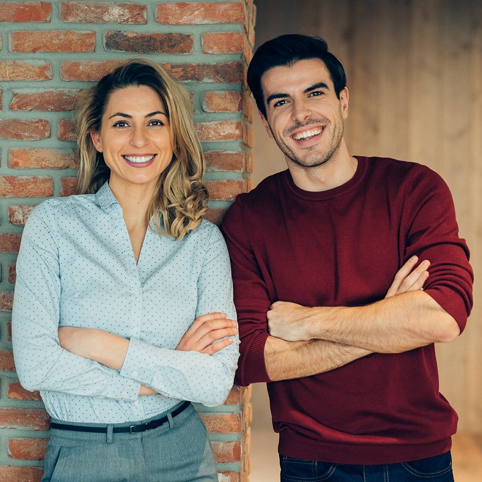Portrait of happy business couple in office